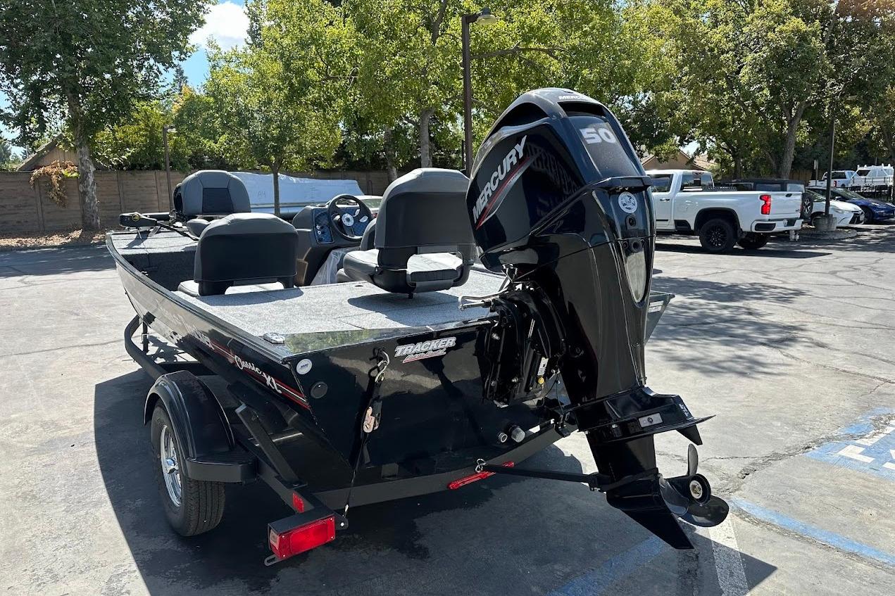 2026 Tracker Bass Tracker Classic XL boat with Mercury engine in a parking lot.