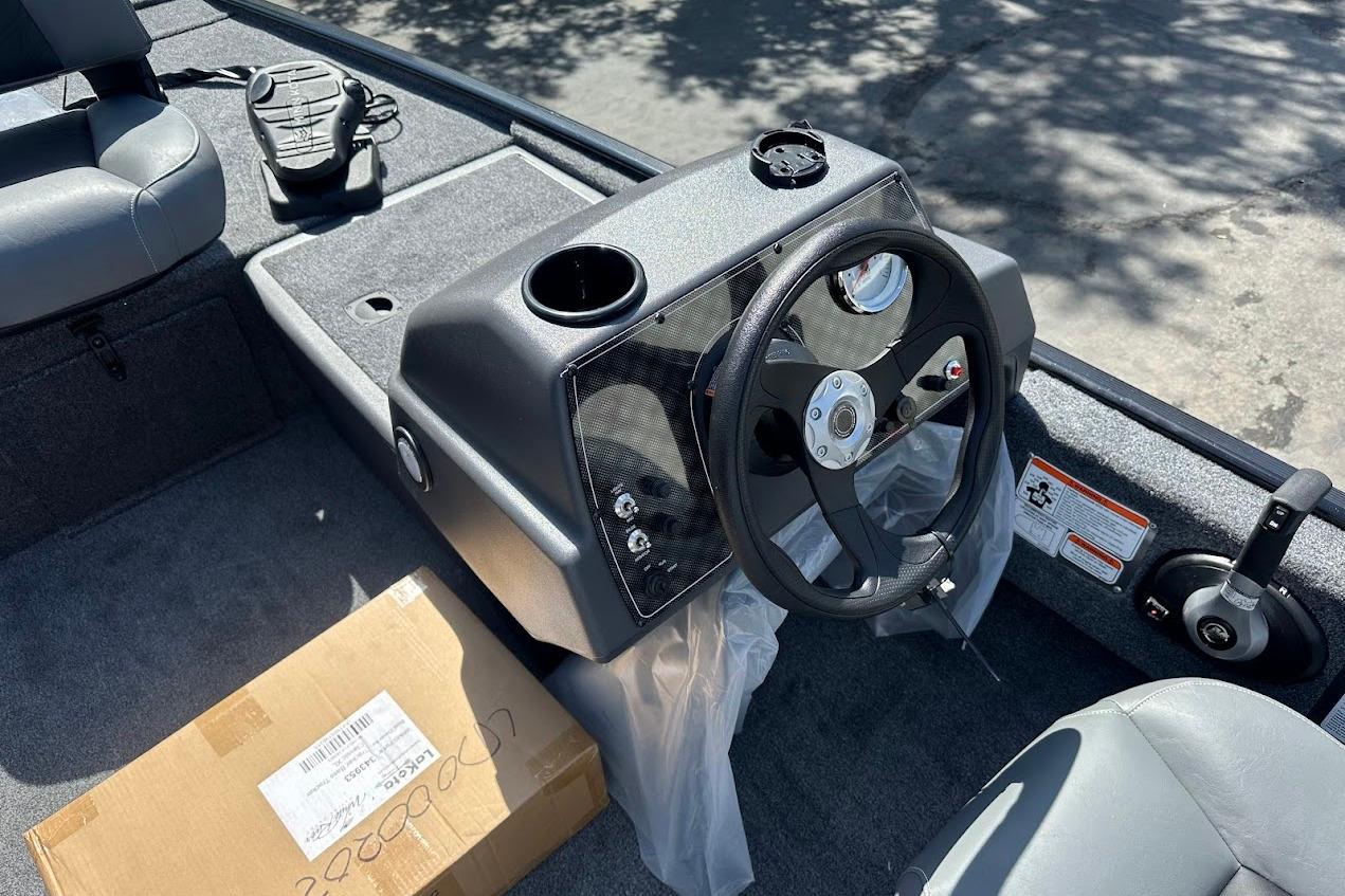 2026 Tracker Bass Tracker Classic XL boat interior with steering wheel and seating.