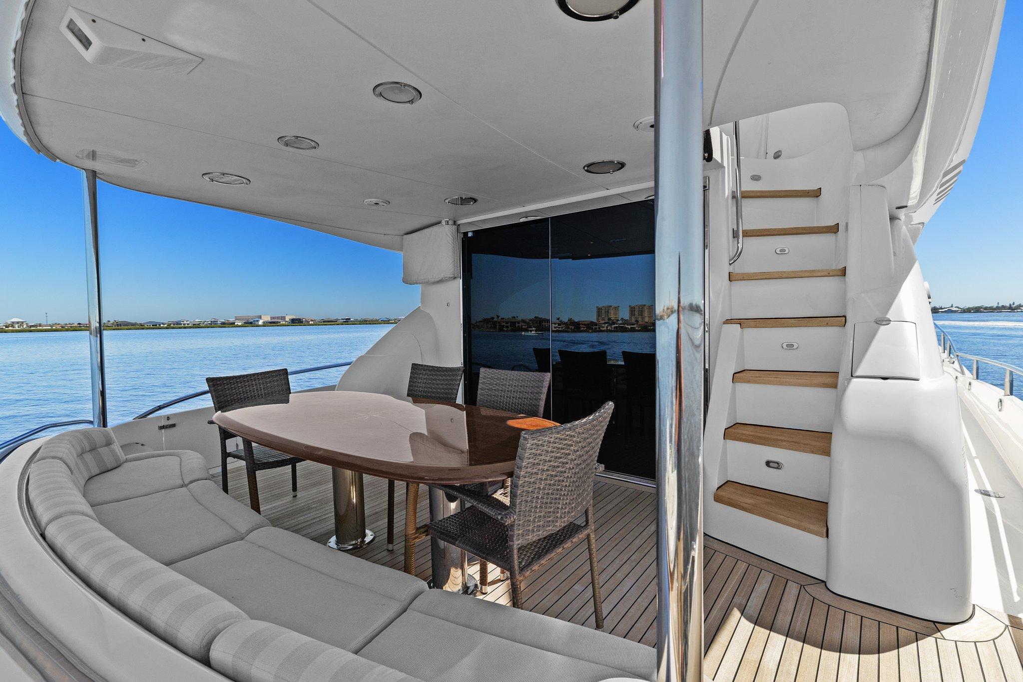 Lazzara-68 Pilothouse Motoryacht 2005 -FL-US-2005 Lazzara 68 Pilothouse Motoryacht deck with seating and table, overlooking serene waters.-9729104 | Thumbnail