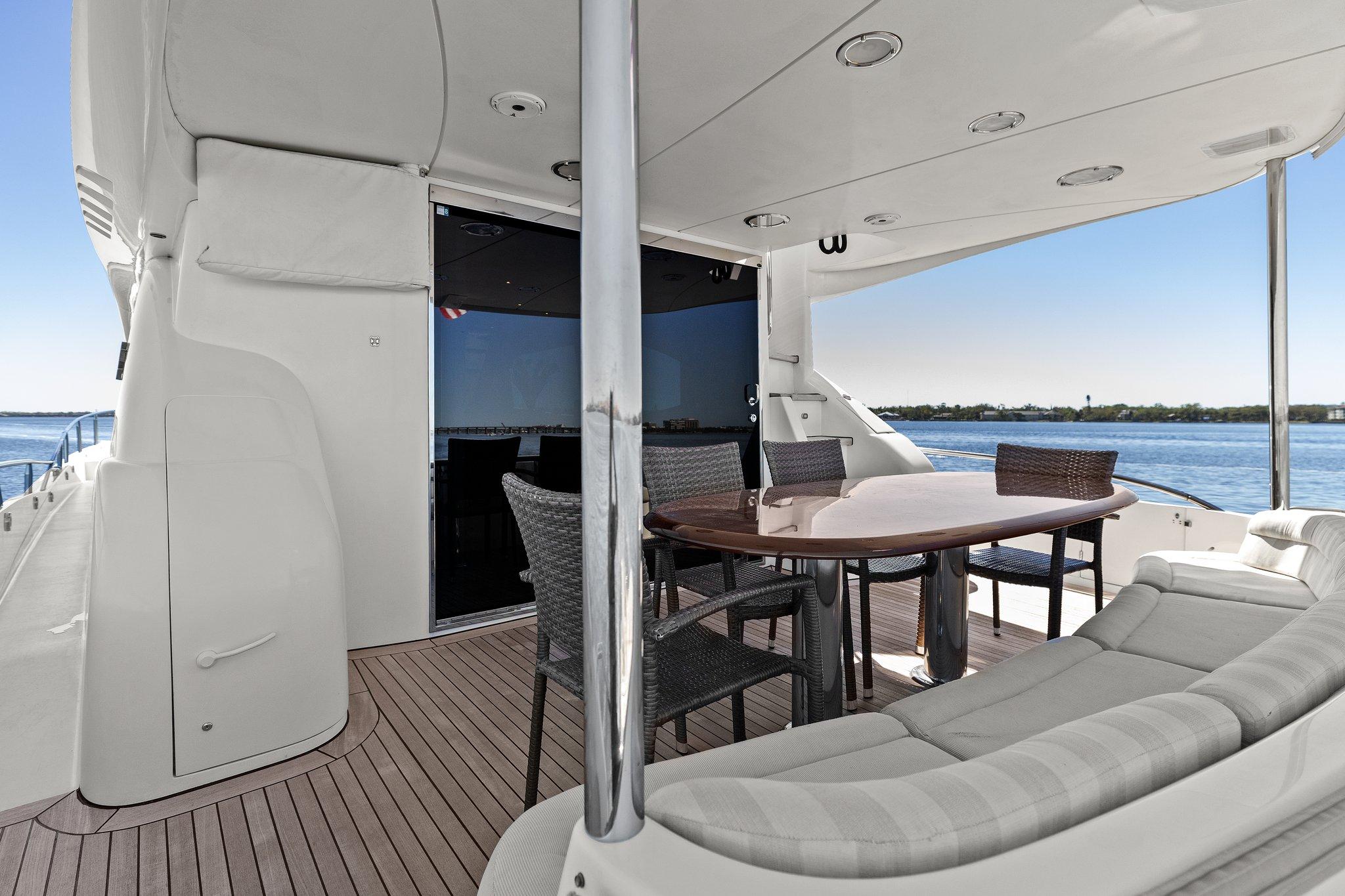 Lazzara-68 Pilothouse Motoryacht 2005 -FL-US-2005 Lazzara 68 Pilothouse Motoryacht deck with seating and dining area, overlooking the water.-9729104 | Thumbnail