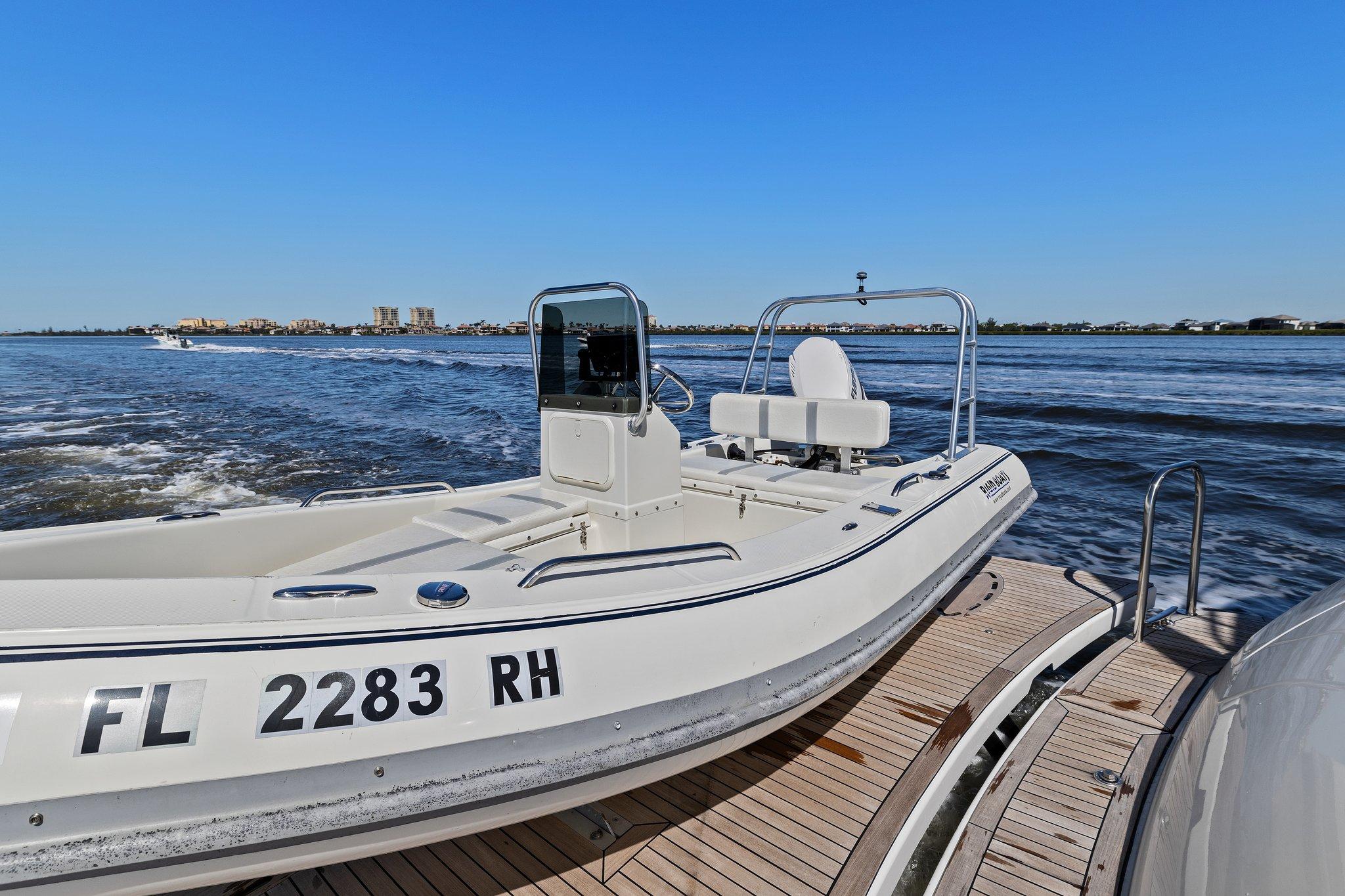 Lazzara-68 Pilothouse Motoryacht 2005 -FL-US-2005 Lazzara 68 Pilothouse Motoryacht with tender on water, clear blue sky.-9729104 | Thumbnail