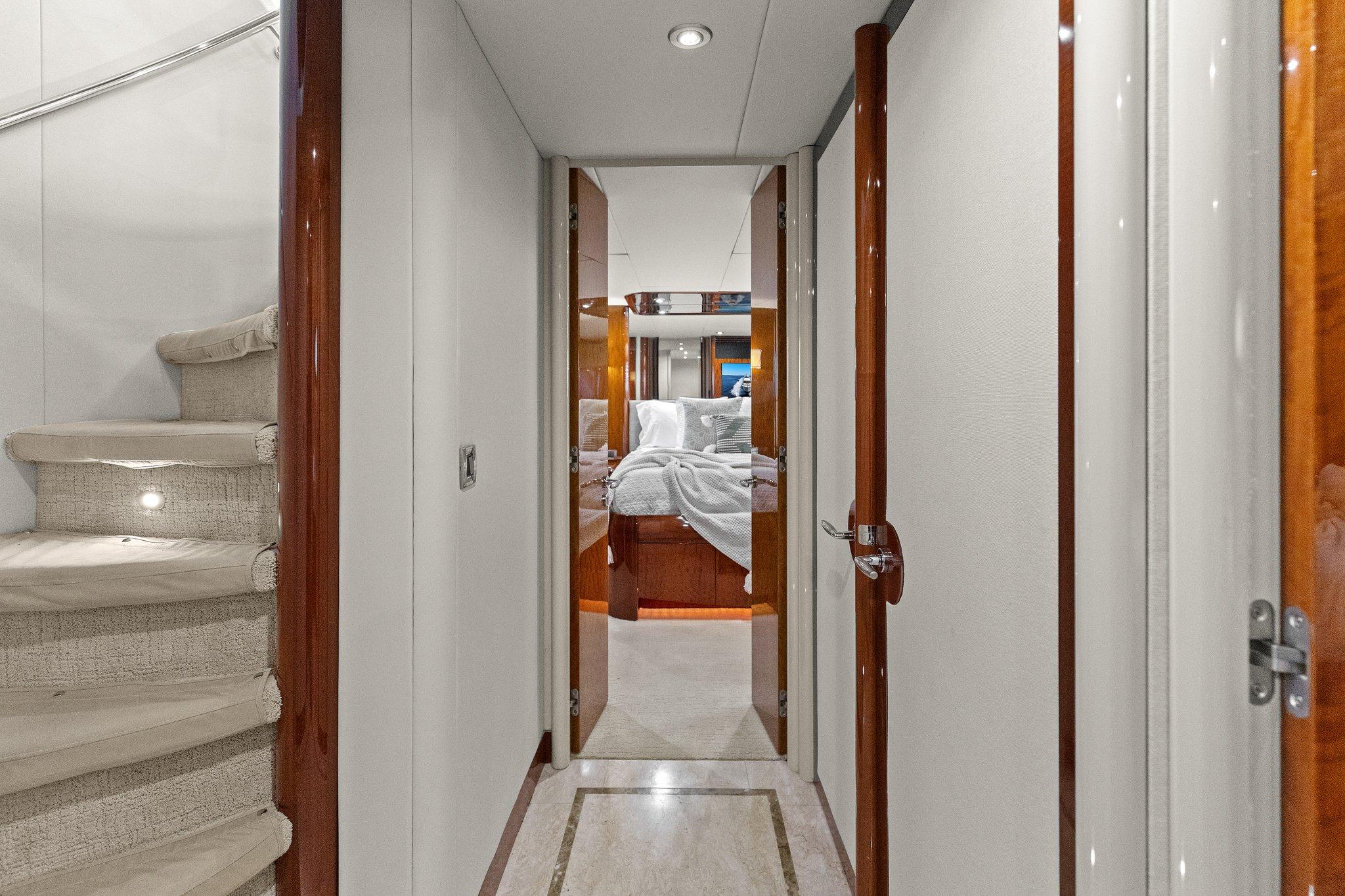 Lazzara-68 Pilothouse Motoryacht 2005 -FL-US-Hallway inside 2005 Lazzara 68 Pilothouse Motoryacht, featuring elegant wood finishes and plush carpeting.-9729104 | Thumbnail