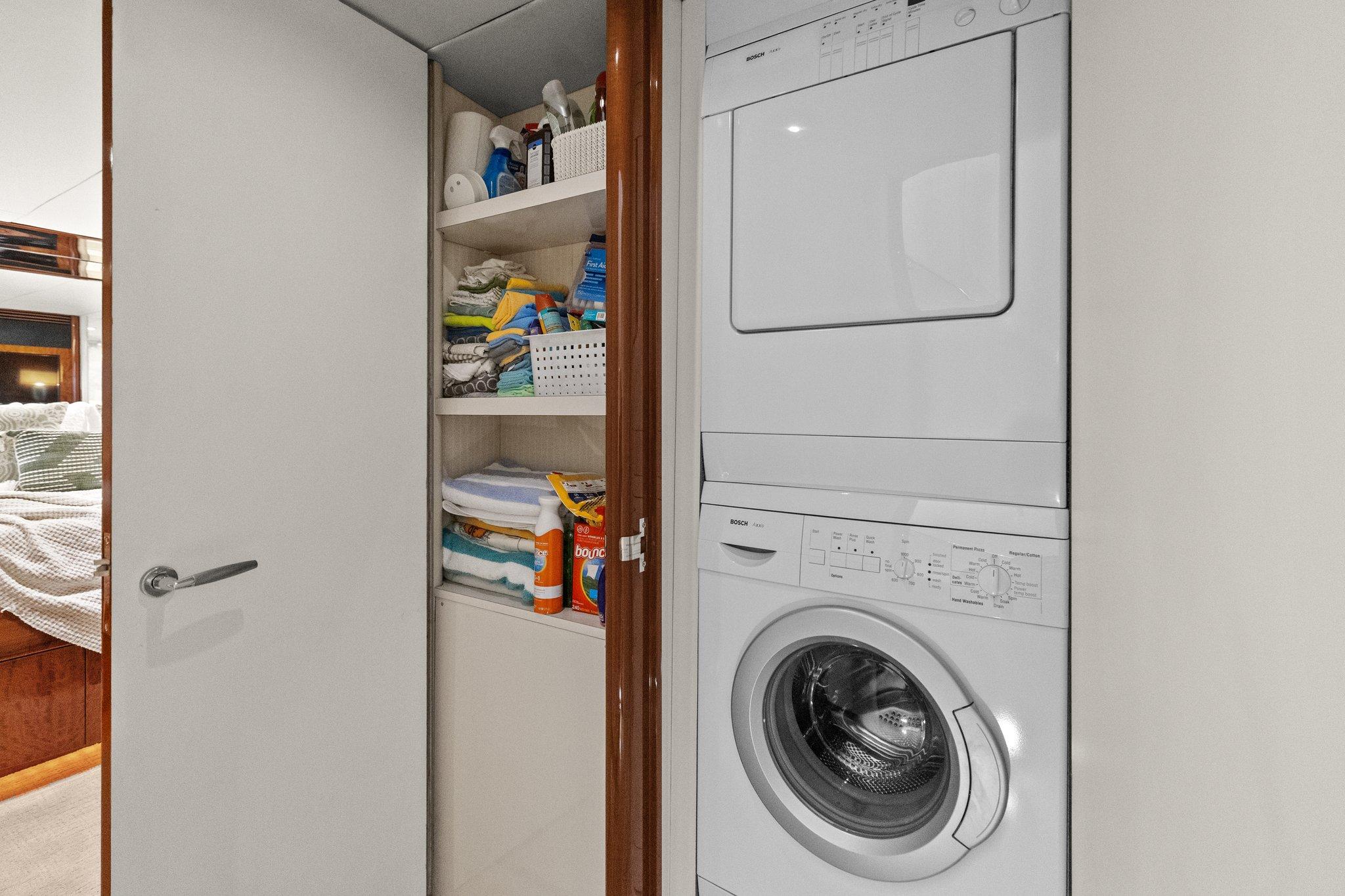 Lazzara-68 Pilothouse Motoryacht 2005 -FL-US-Laundry area with stacked washer-dryer and storage in 2005 Lazzara 68 Pilothouse Motoryacht.-9729104 | Thumbnail