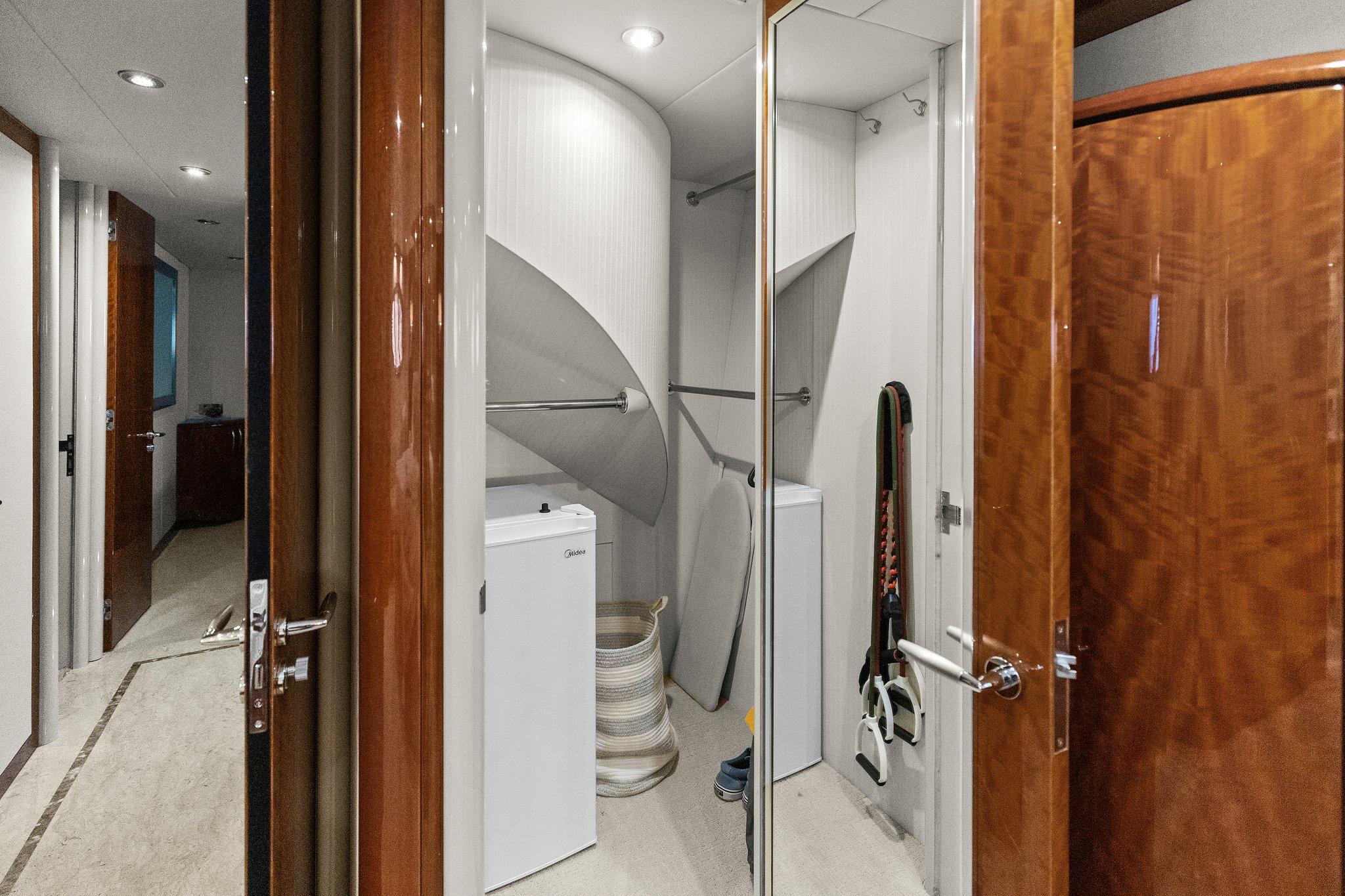 Lazzara-68 Pilothouse Motoryacht 2005 -FL-US-Laundry area in 2005 Lazzara 68 Pilothouse Motoryacht with washer, dryer, and storage space.-9729104 | Thumbnail