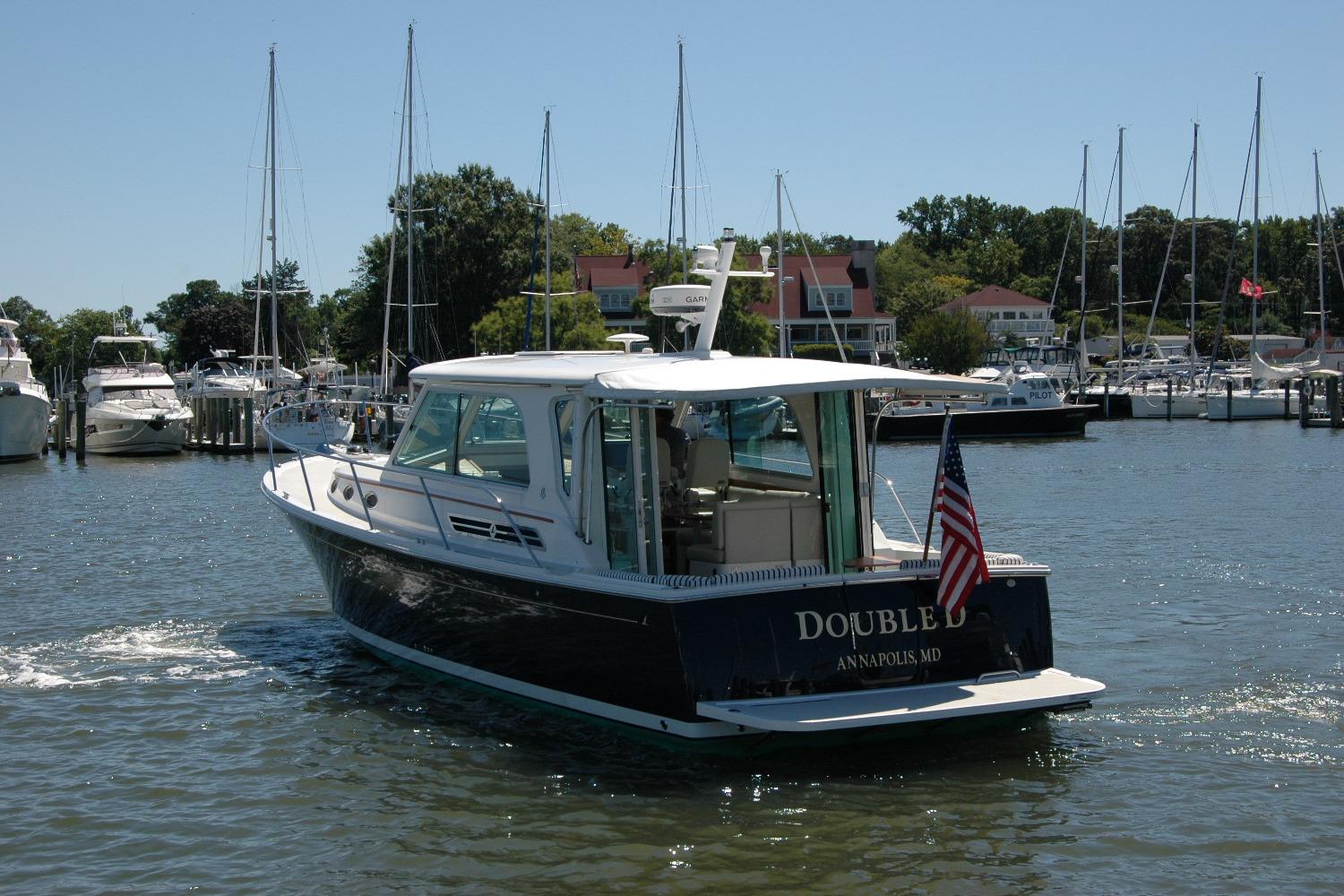 2014 Back Cove 37 boat in marina, Annapolis, MD, with American flag.