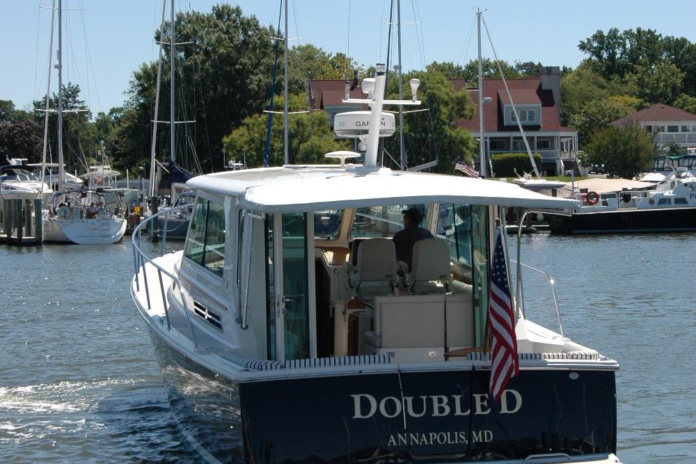 2014 Back Cove 37 boat in marina, Annapolis, MD, with American flag.