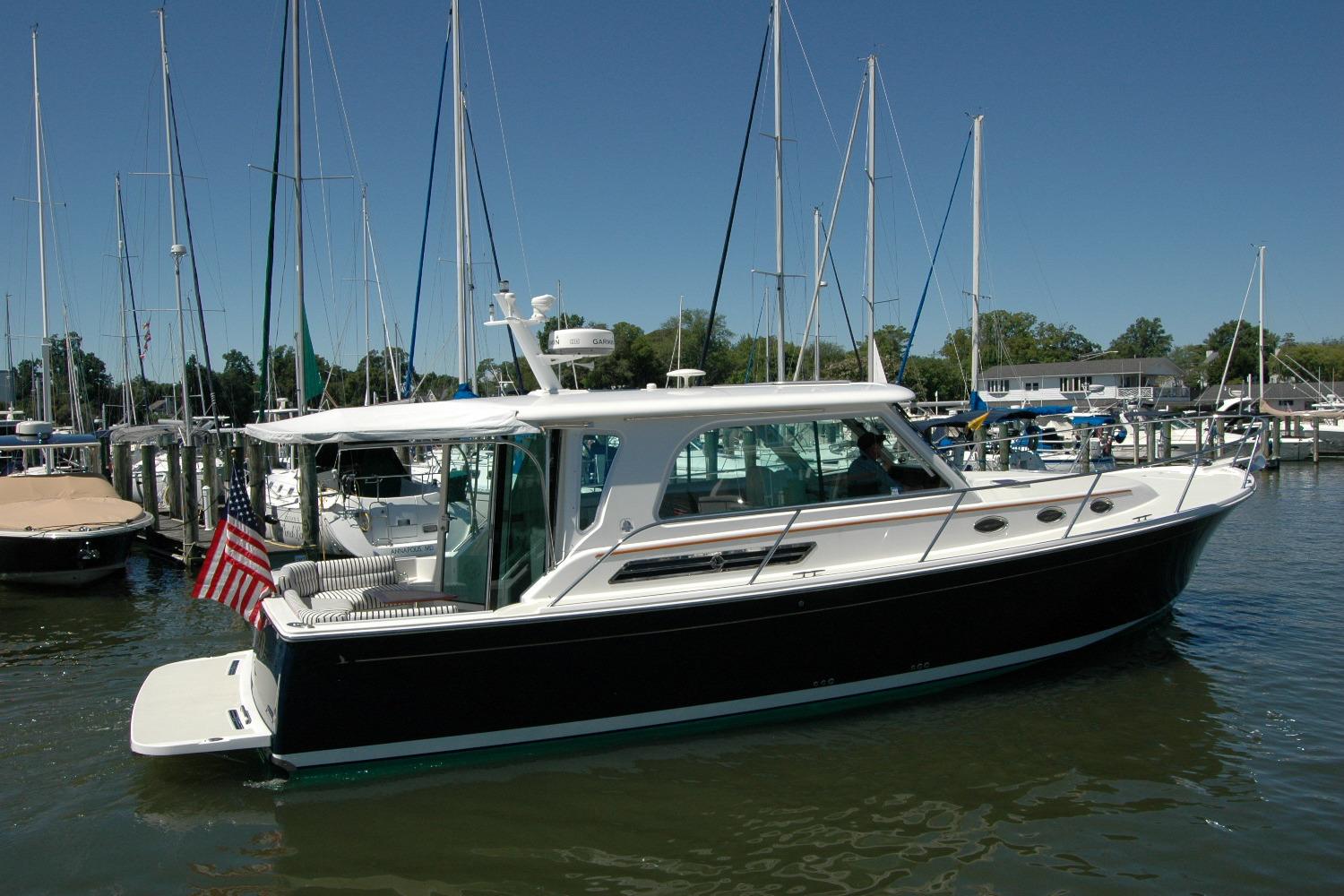 2014 Back Cove 37 yacht docked in a marina under clear blue skies.