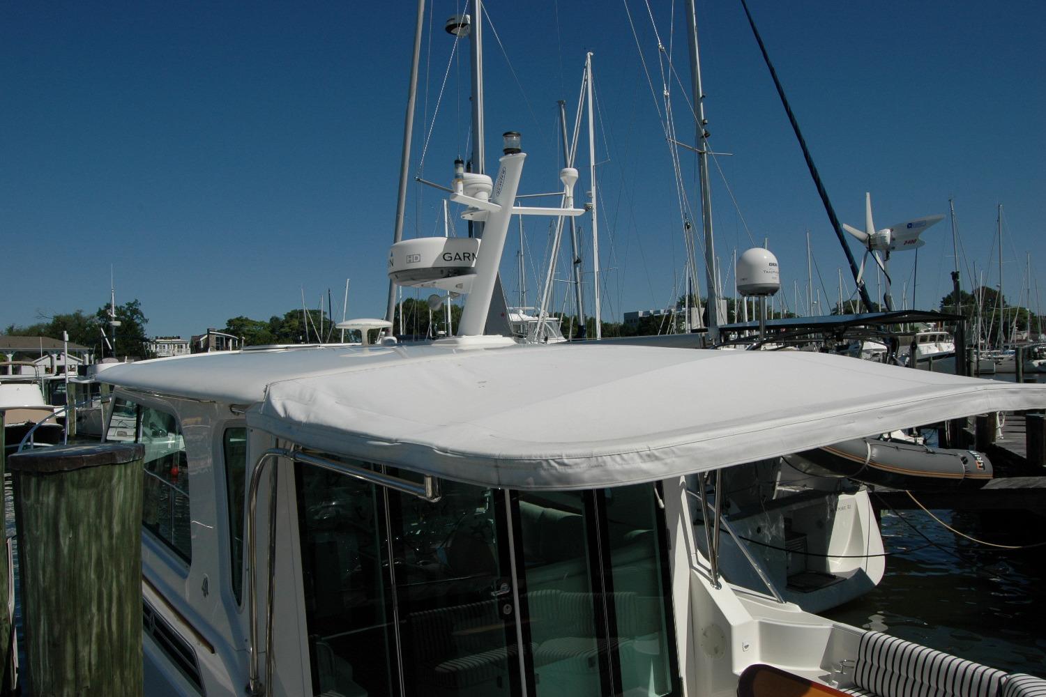 2014 Back Cove 37 yacht docked at marina under clear blue sky.