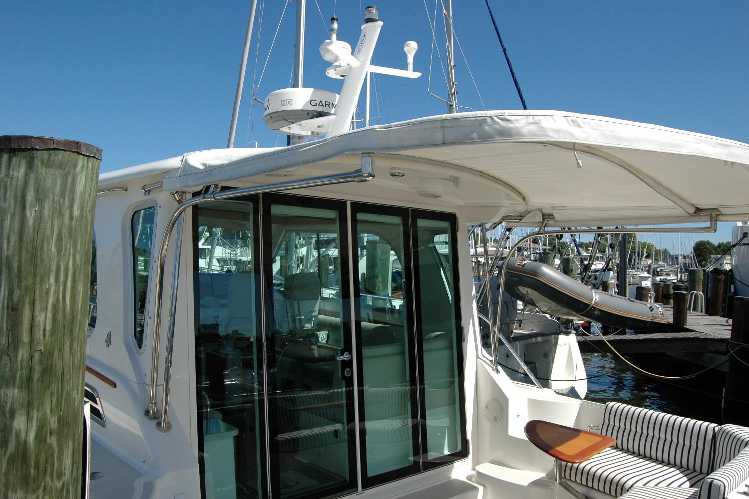 2014 Back Cove 37 yacht docked, featuring a sleek design and spacious interior.