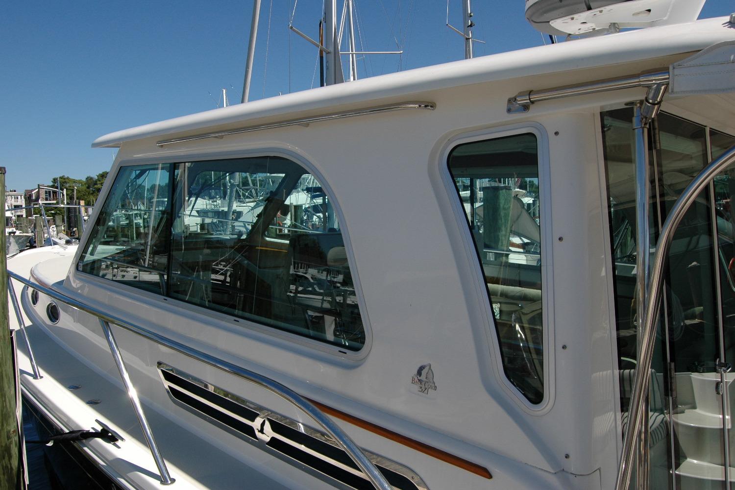 2014 Back Cove 37 yacht docked, showcasing sleek windows and polished railings.