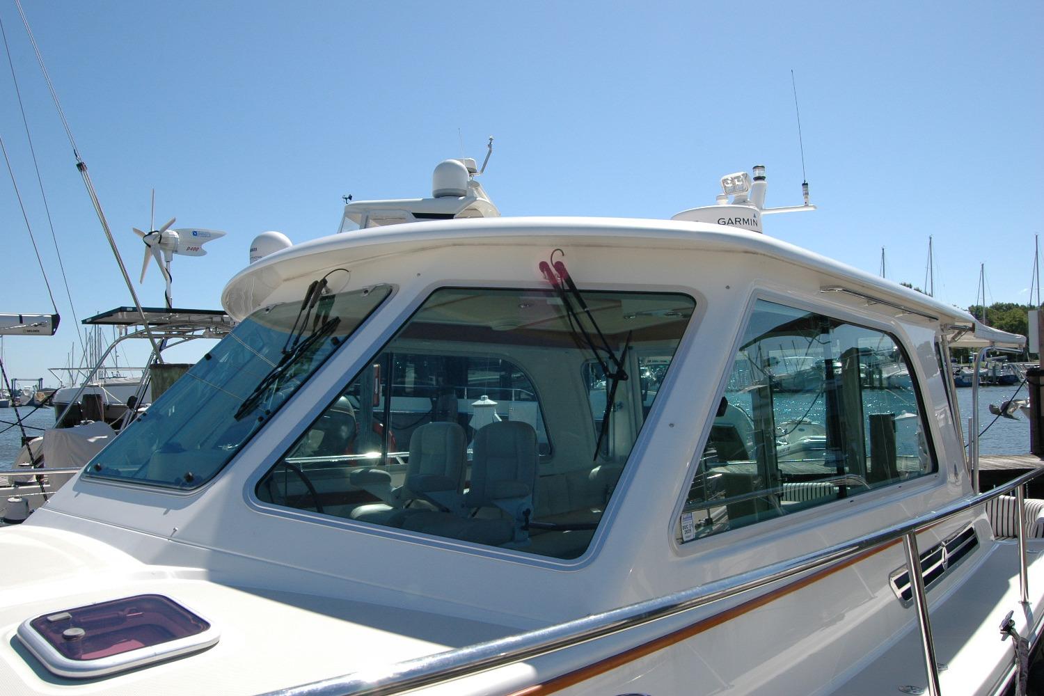 2014 Back Cove 37 yacht docked, showcasing sleek design and modern navigation equipment.