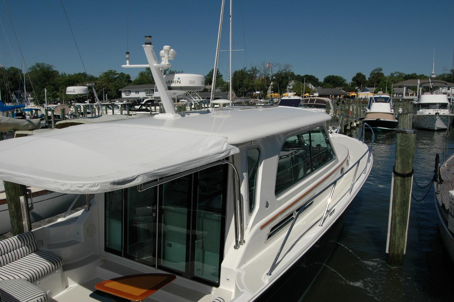 2014 Back Cove 37 yacht docked at marina under clear blue sky.