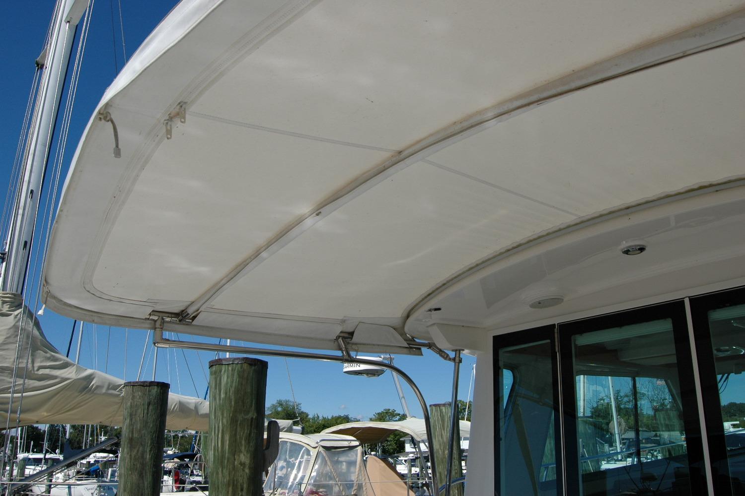 2014 Back Cove 37 yacht with covered deck at marina.
