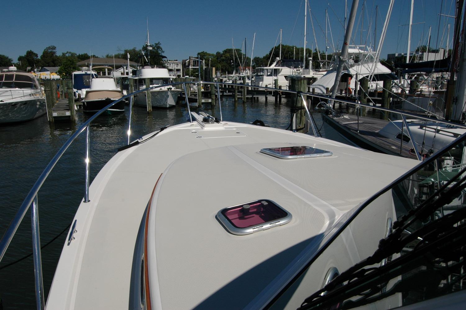 2014 Back Cove 37 yacht docked at marina, showcasing sleek deck design.