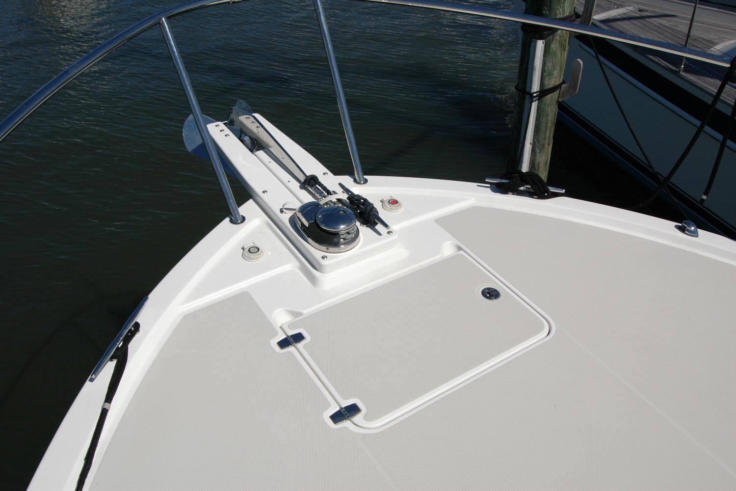 2014 Back Cove 37 boat deck with anchor and railing in marina.