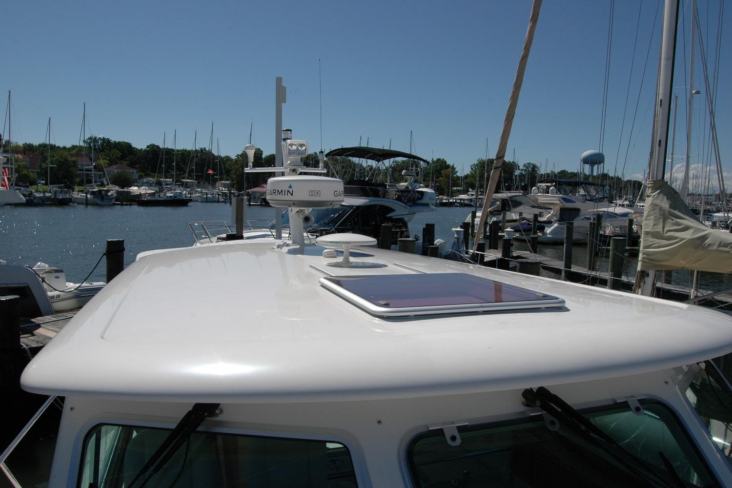 2014 Back Cove 37 yacht docked at marina, featuring Garmin radar and clear sky.