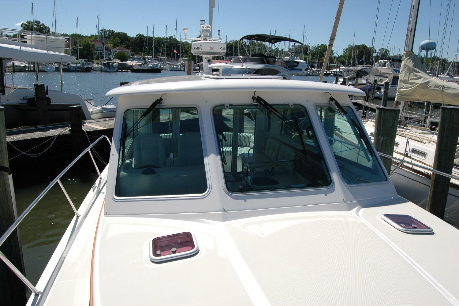 2014 Back Cove 37 boat docked at a marina, showcasing its cabin and windshield.