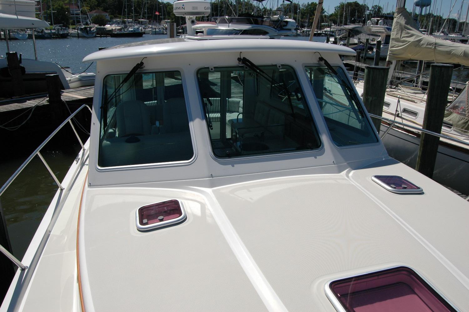 2014 Back Cove 37 boat docked at marina, showcasing front deck and windows.