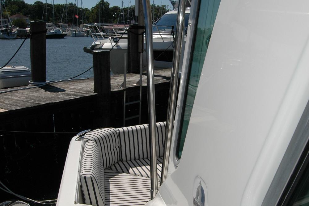 2014 Back Cove 37 yacht with striped seating at a marina dock.