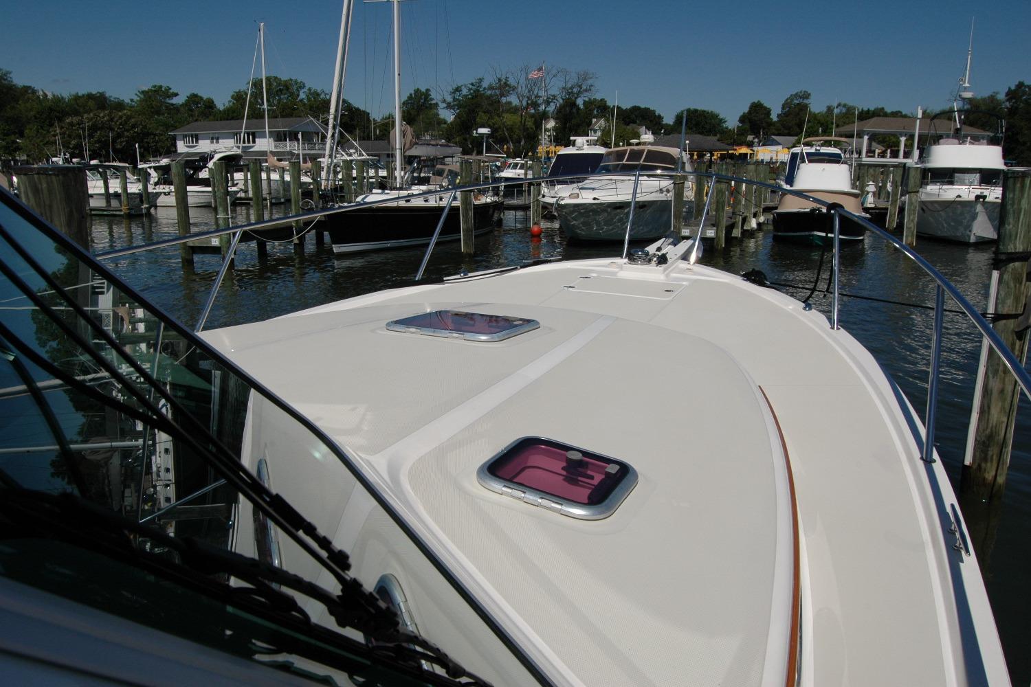 2014 Back Cove 37 yacht docked in a marina, showcasing its sleek deck design.
