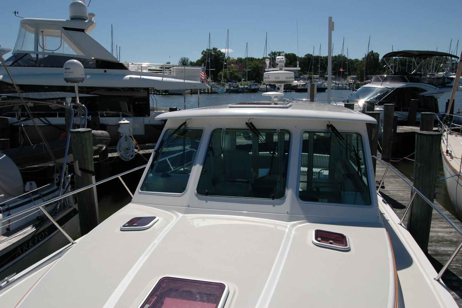 2014 Back Cove 37 yacht docked at marina, surrounded by other boats.