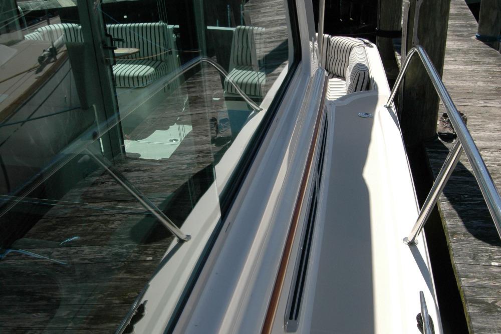 2014 Back Cove 37 yacht with striped seating and sleek glass windows.