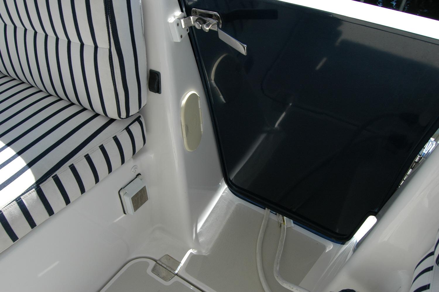 2014 Back Cove 37 boat interior with striped seating and dark glass door.