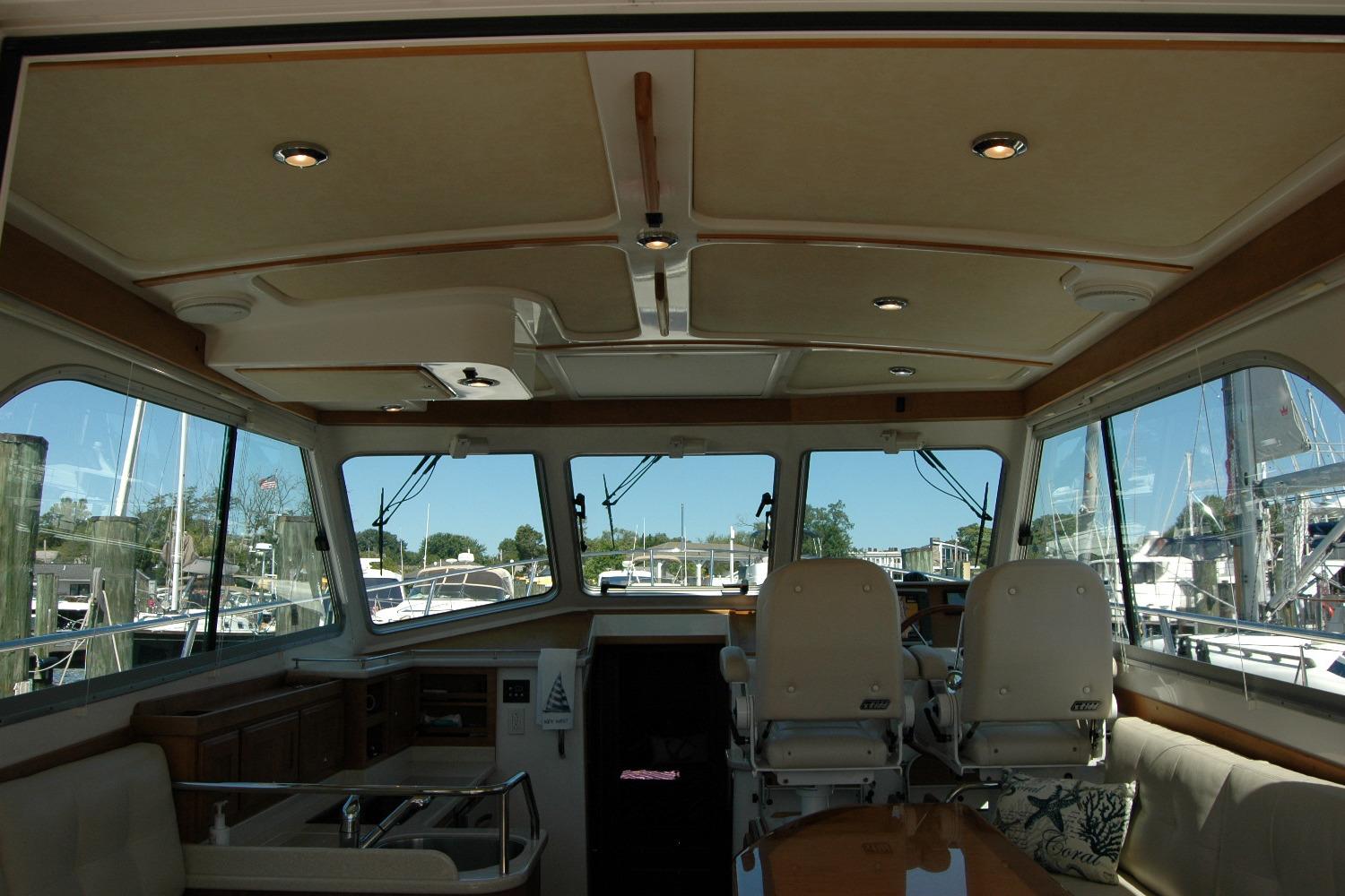 Interior view of 2014 Back Cove 37 yacht with helm and seating area.