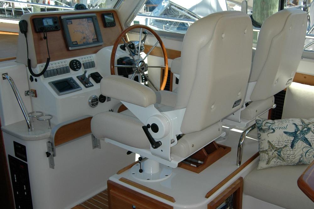Helm station of 2014 Back Cove 37 with dual seats and navigation equipment.
