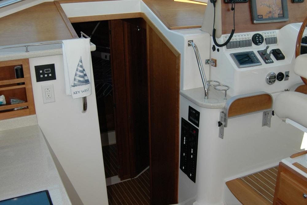 Interior of 2014 Back Cove 37 yacht with navigation controls and wooden accents.