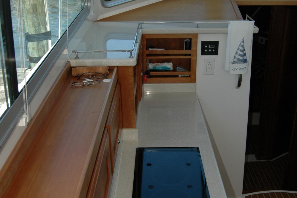Interior of 2014 Back Cove 37 yacht, featuring a sleek countertop and storage area.