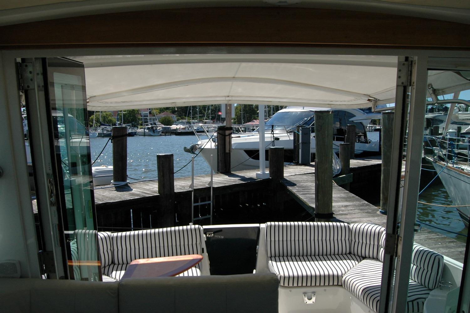 2014 Back Cove 37 yacht interior with striped seating, docked at marina.