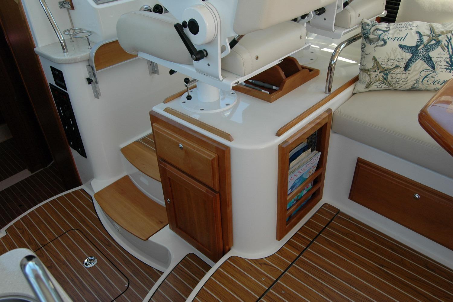 2014 Back Cove 37 yacht interior with wooden cabinetry and seating area.