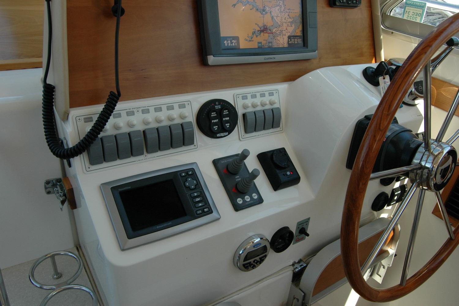 2014 Back Cove 37 helm with navigation controls and wooden steering wheel.