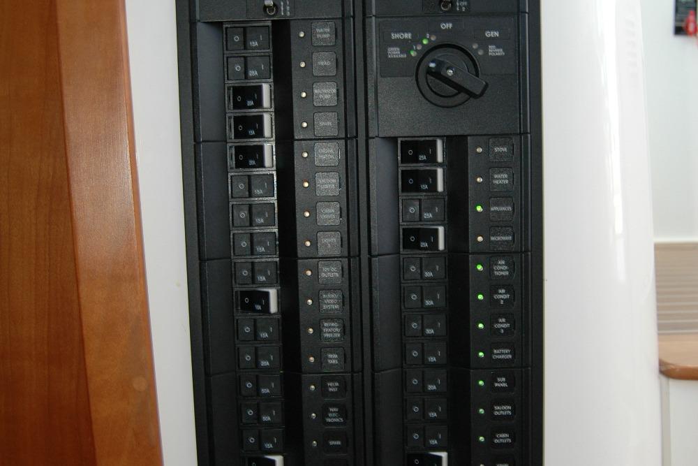 Electrical panel of a 2014 Back Cove 37 boat, featuring circuit breakers and switches.