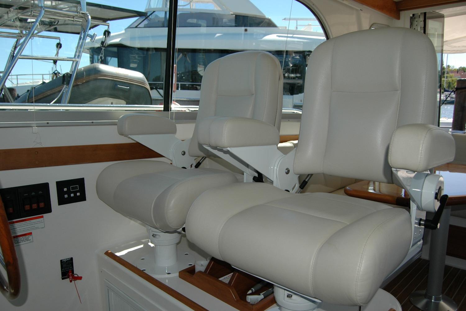 Interior of 2014 Back Cove 37 yacht with two white captainu0027s chairs.