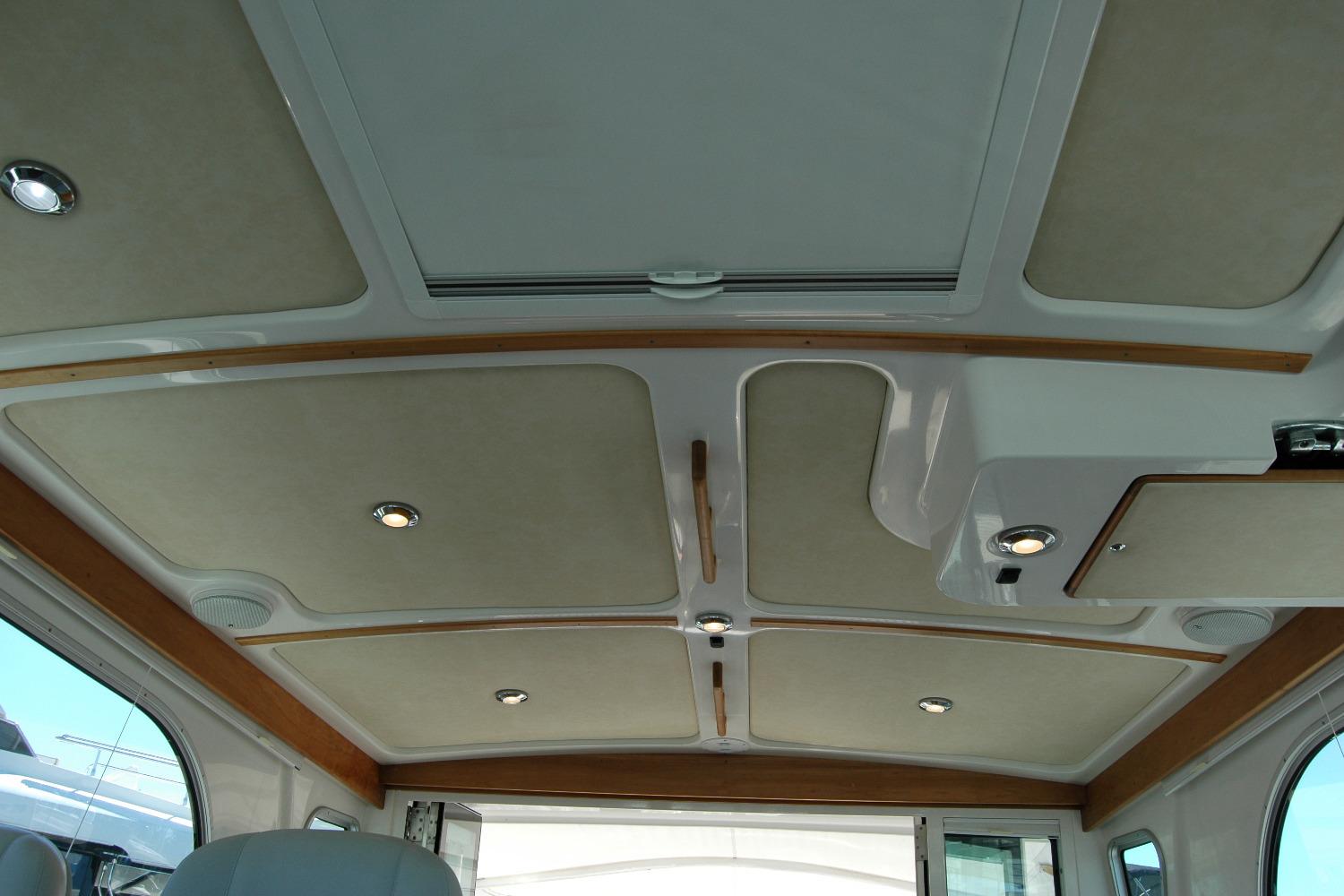 Interior ceiling of a 2014 Back Cove 37 boat with recessed lighting and wood accents.