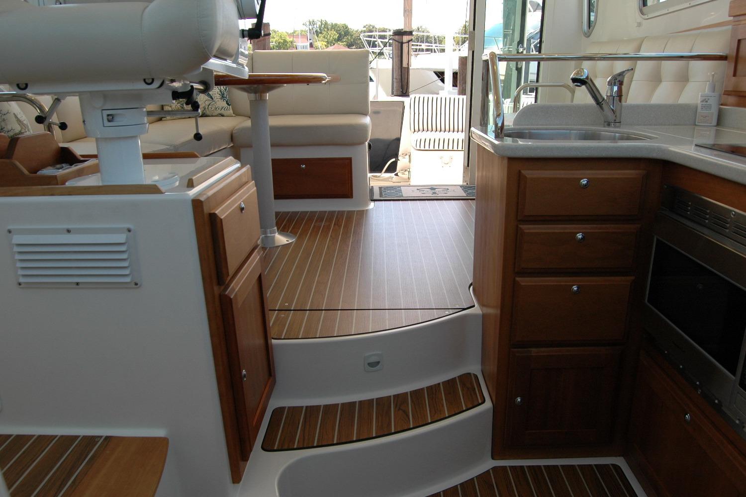 Interior of a 2014 Back Cove 37 boat featuring a kitchen and seating area.