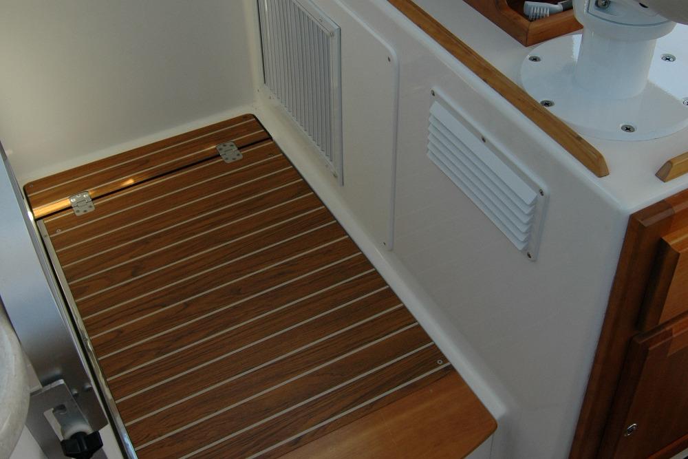 2014 Back Cove 37 interior with wooden flooring and white paneling.