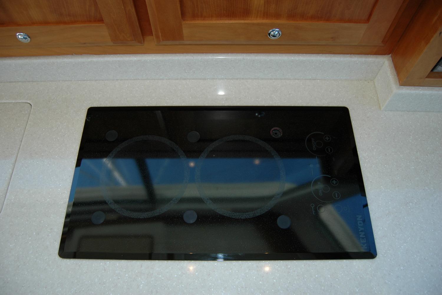 Stovetop on 2014 Back Cove 37 yacht with sleek black glass surface.