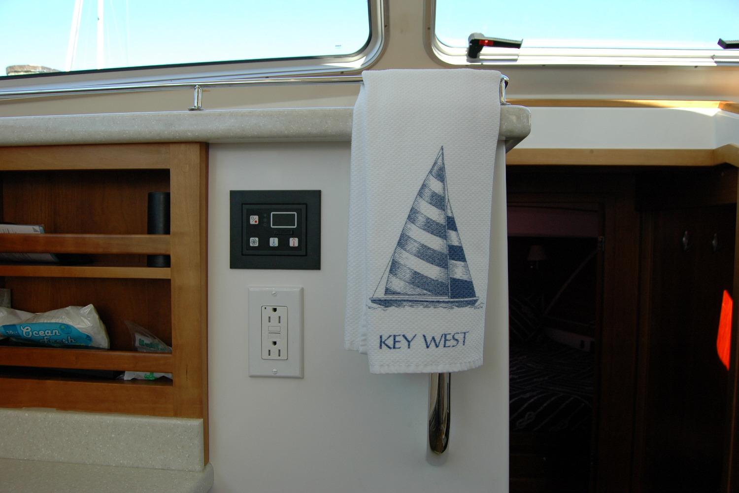 Interior of 2014 Back Cove 37 boat with Key West towel and control panel.