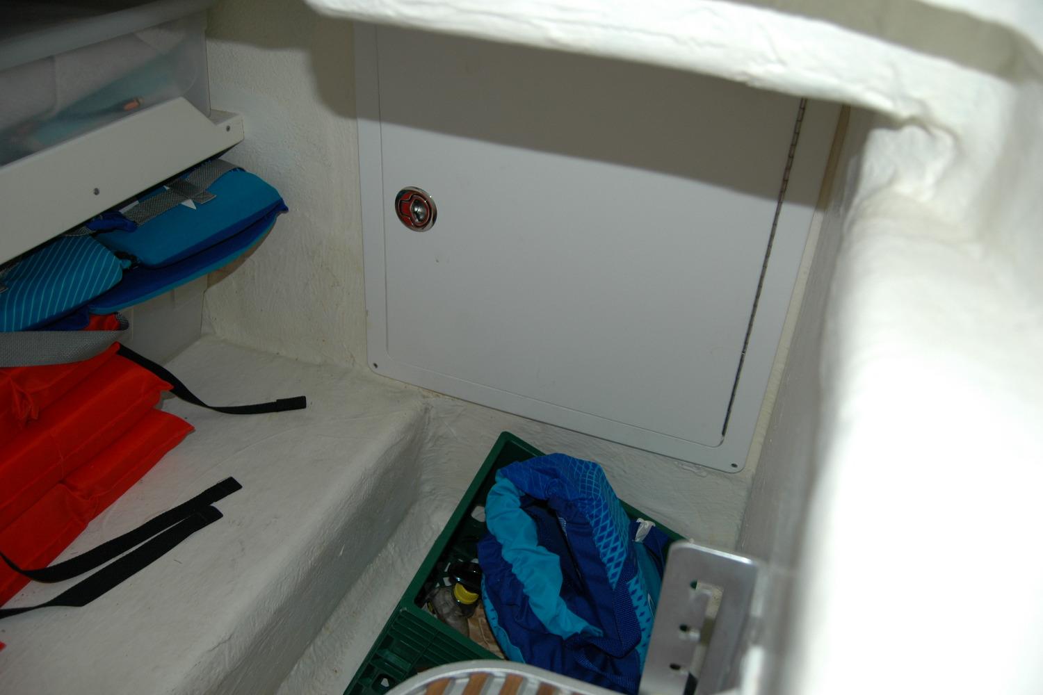 Storage compartment in a 2014 Back Cove 37 boat with life jackets and gear.