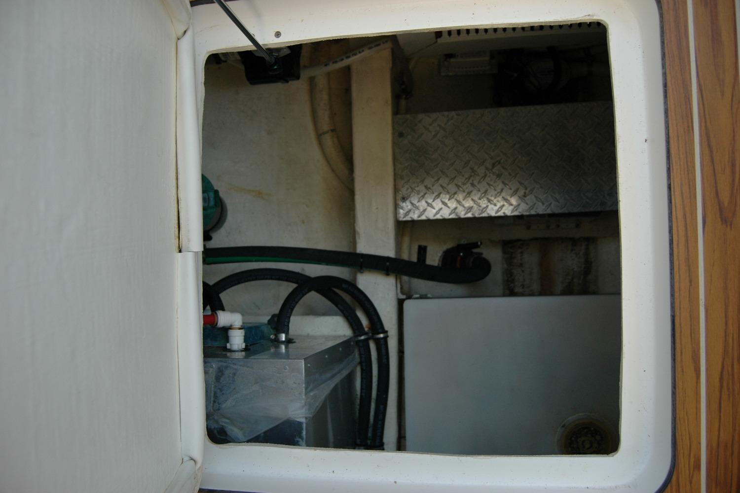2014 Back Cove 37 engine compartment with hoses and metal panel.