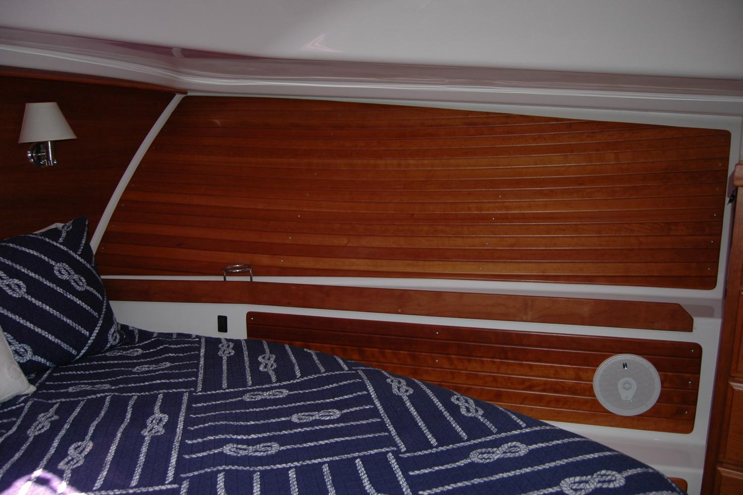 2014 Back Cove 37 interior cabin with wood paneling and nautical-themed bedding.