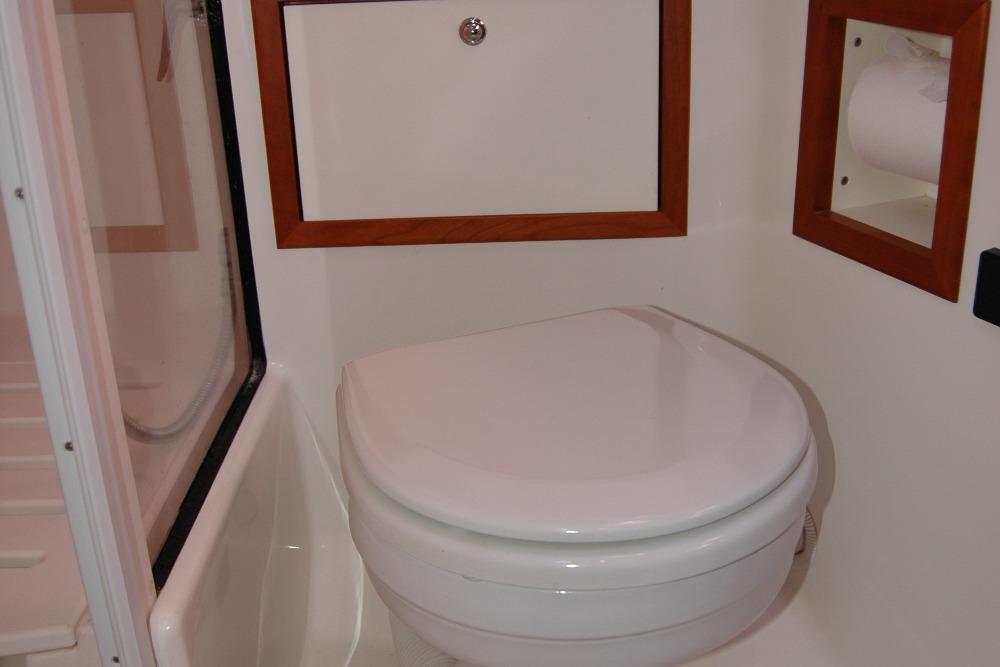 2014 Back Cove 37 yacht bathroom with toilet and wooden accents.