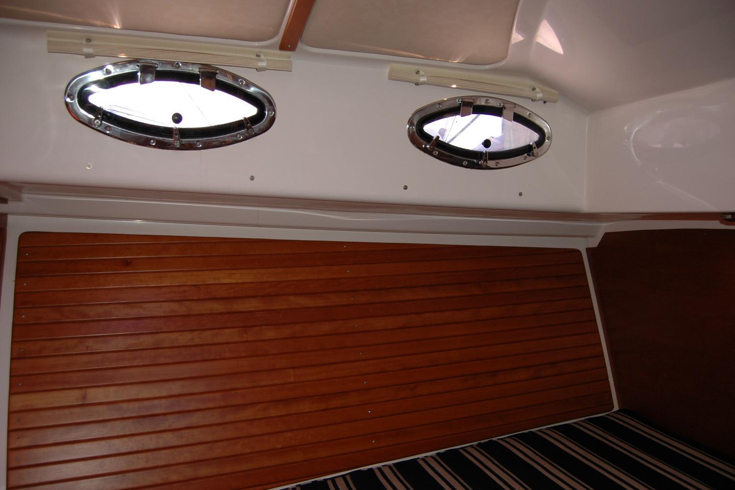 2014 Back Cove 37 interior with wood paneling and oval portholes.