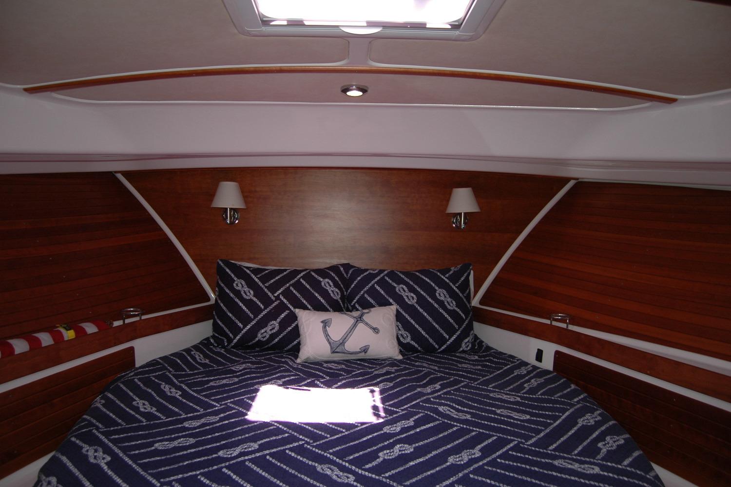 Luxurious cabin interior of 2014 Back Cove 37 yacht with nautical-themed bedding.