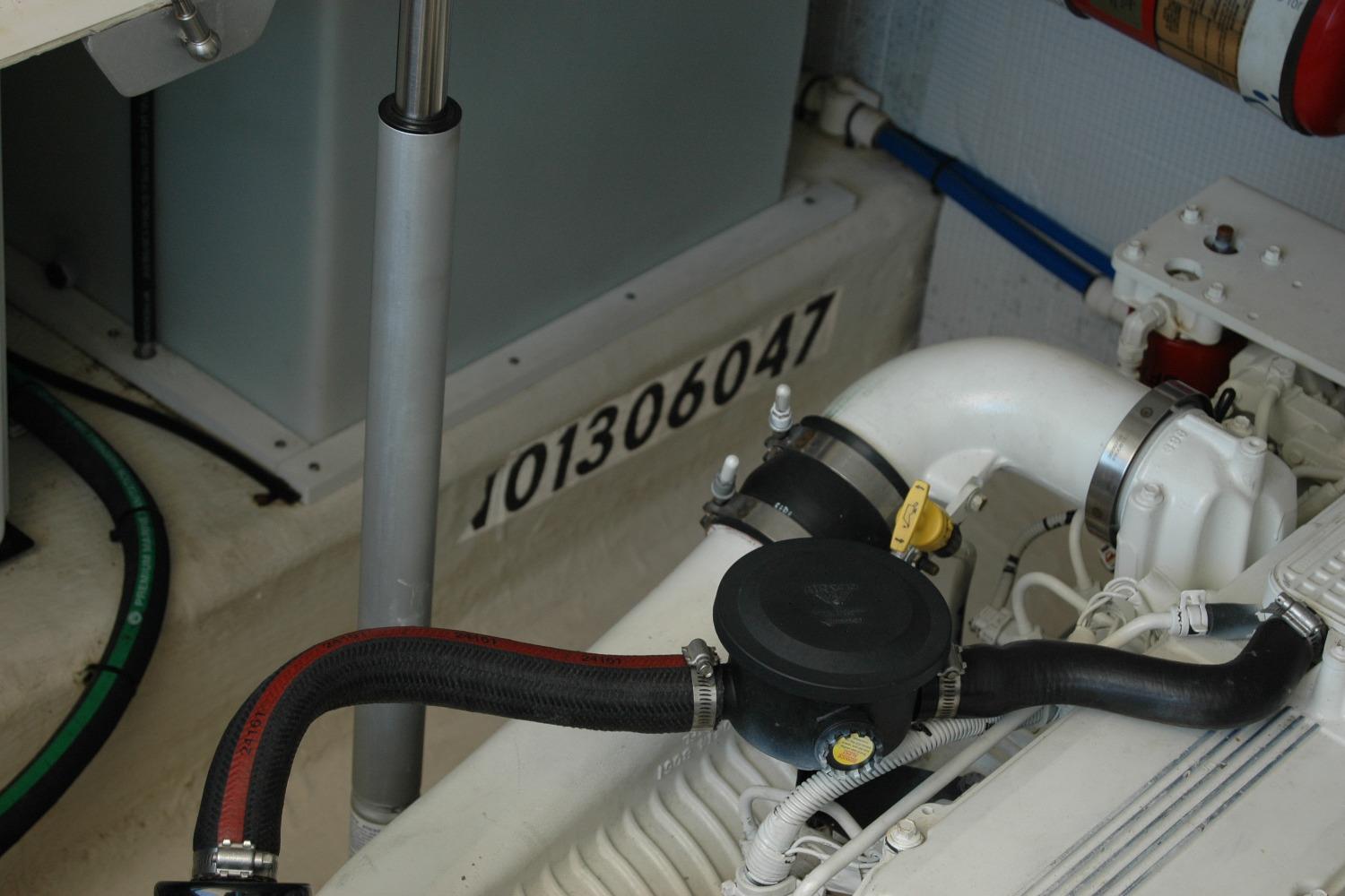 Engine compartment of a 2014 Back Cove 37 boat, showcasing mechanical components.