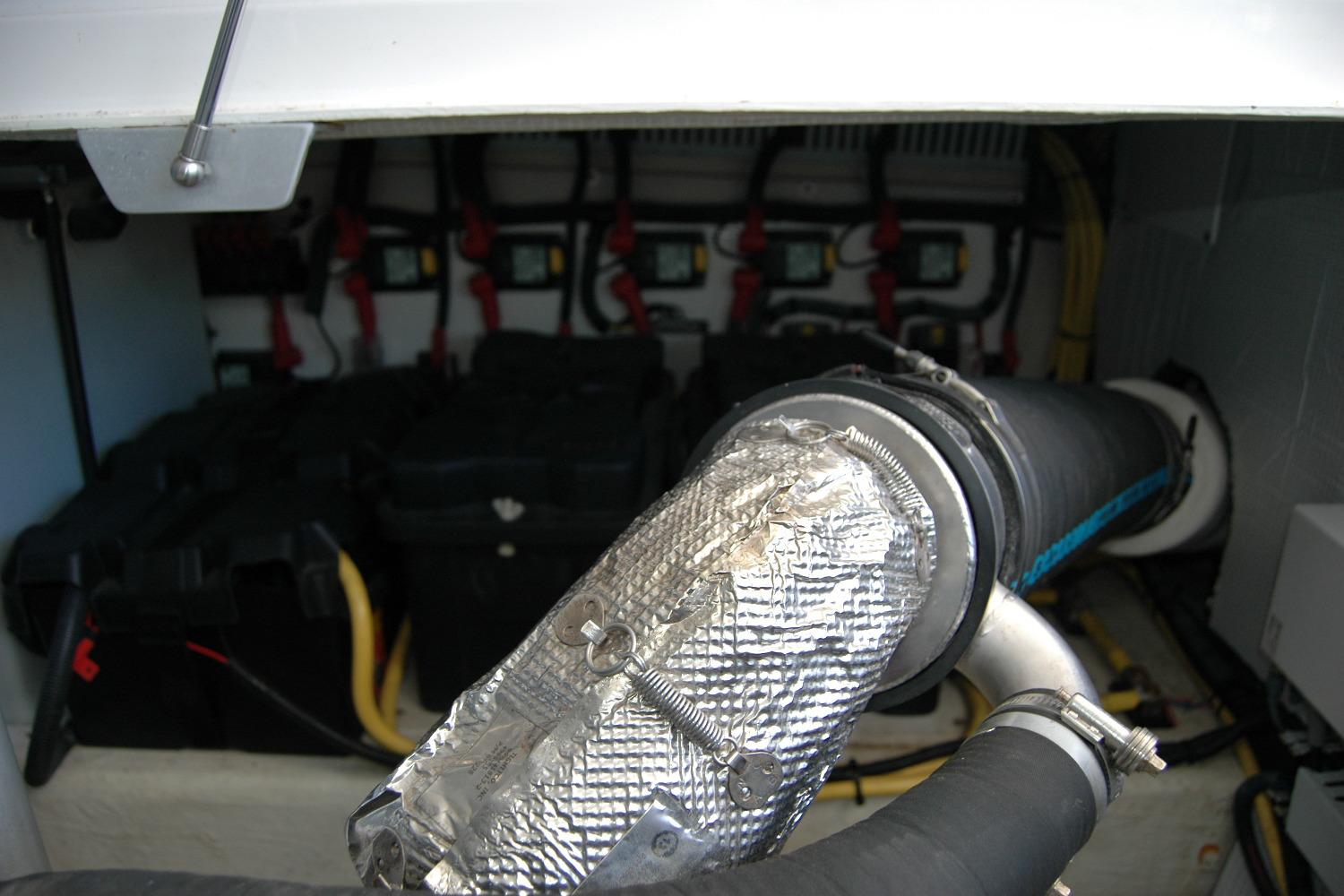 Engine compartment of a 2014 Back Cove 37 boat, showing exhaust and battery setup.