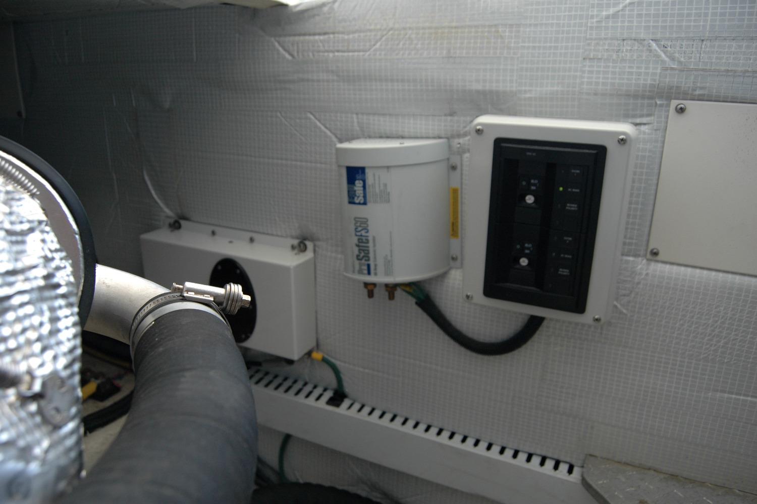 Engine room of 2014 Back Cove 37 with fuel filter and control panel.